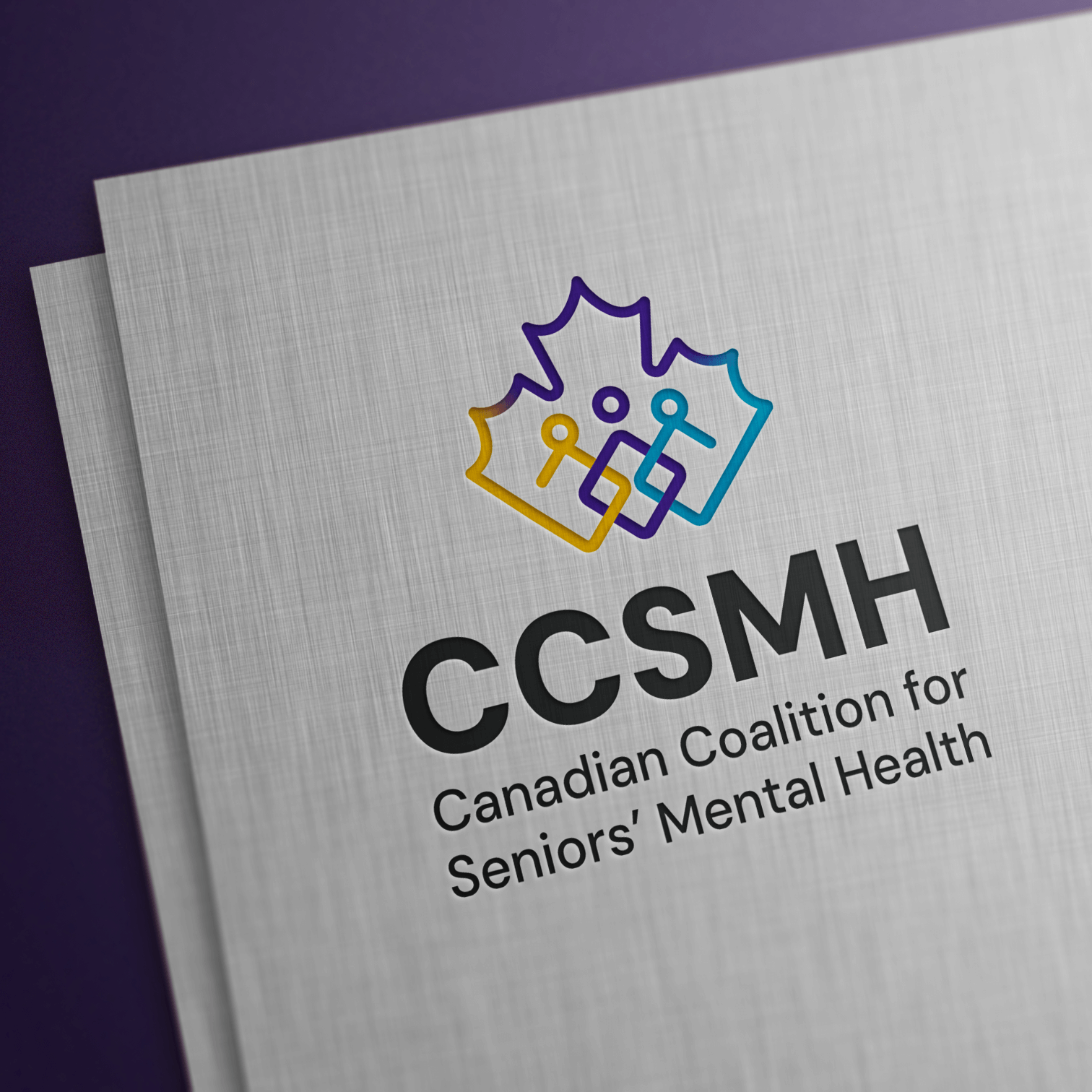 The CCSMH colour logo embossed on a linen paper stock. 