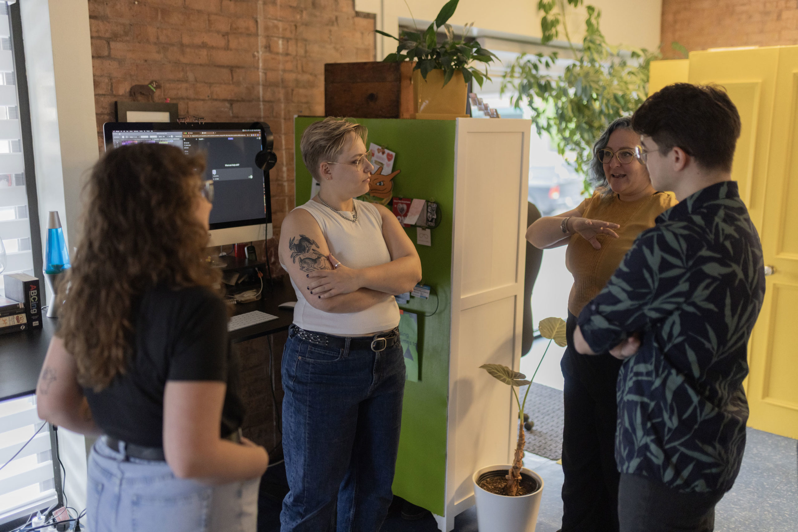 The Frolic Design team having a discussion about graphic design in the studio